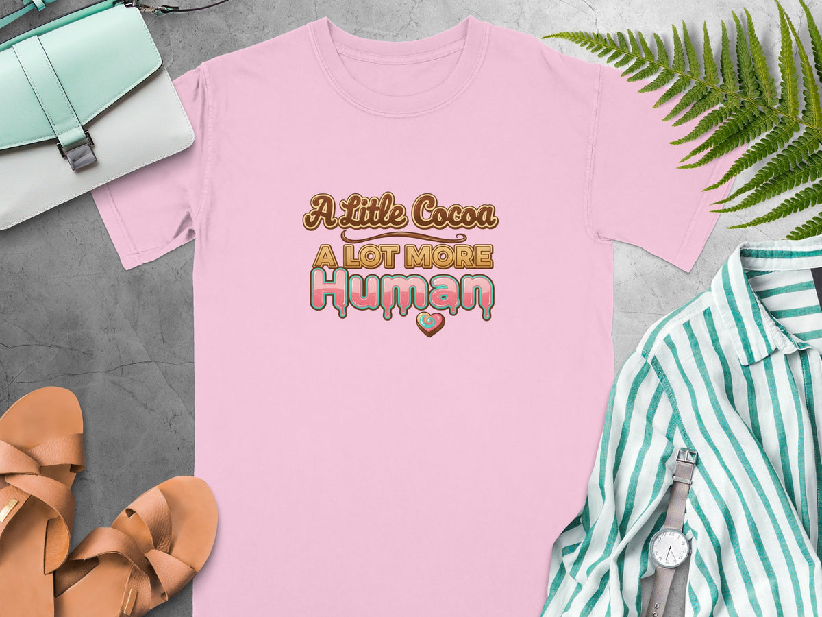 Pink t-shirt with "A Little Cocoa A LOT MORE Human" text and heart detail.