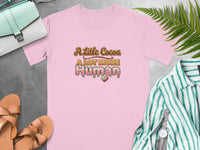Pink t-shirt with "A Little Cocoa A LOT MORE Human" text and heart detail.