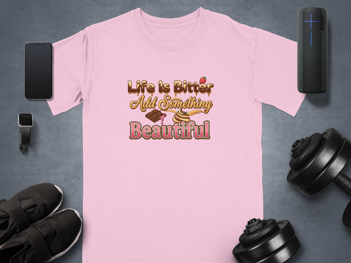 Pink t-shirt with "Life is Bitter Add Something Beautiful" text and dessert graphics.