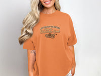 Orange t-shirt with "Let the day be messy, Keep the Chocolate Good" text and chocolate bar graphic.