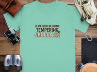 Teal t-shirt with text "ID RATHER BE HOME TEMPERING CHOCOLATE."