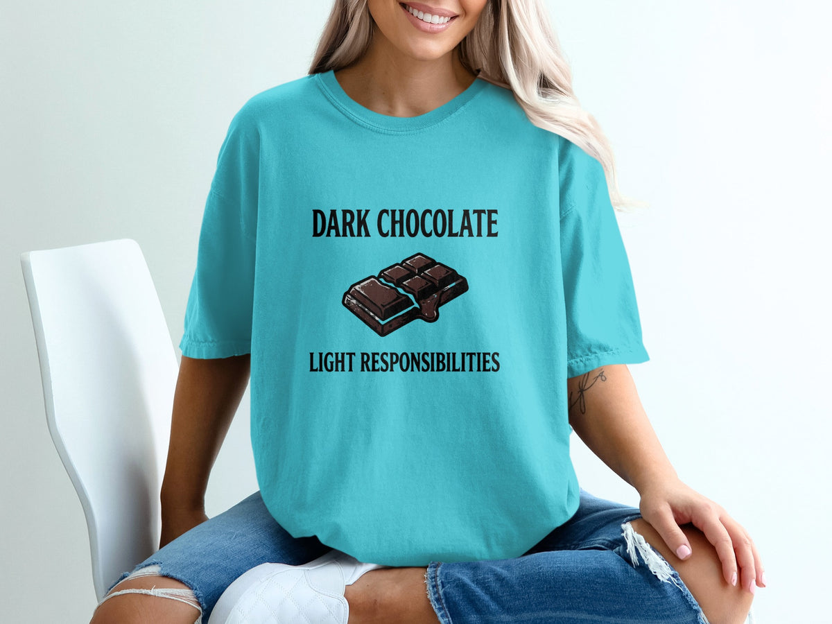 Teal t-shirt with "Dark Chocolate Light Responsibilities" text and chocolate bar graphic.