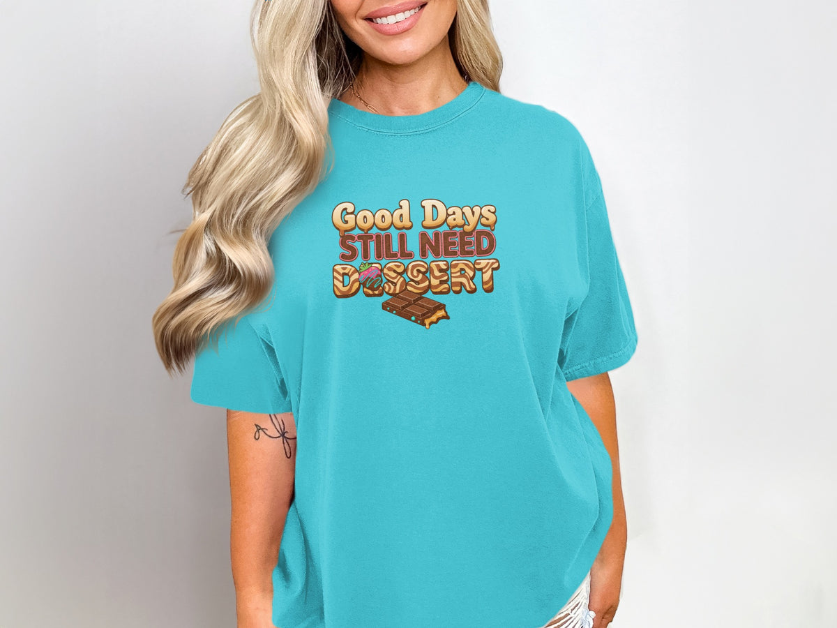 Turquoise t-shirt with "Good Days Still Need Dessert" graphic featuring chocolate and donuts.