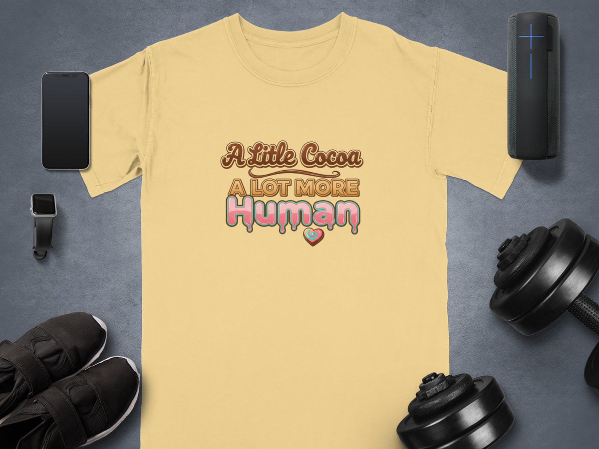 Yellow t-shirt with "A Little Cocoa A LOT MORE Human" text and heart graphic.