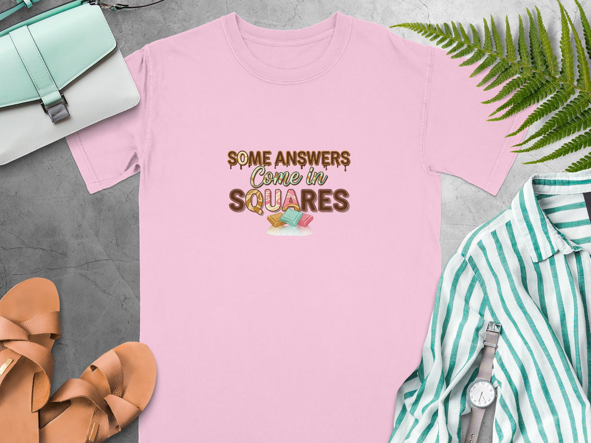 Pink t-shirt with text "SOME ANSWERS Come in SQUARES" and candy graphics.