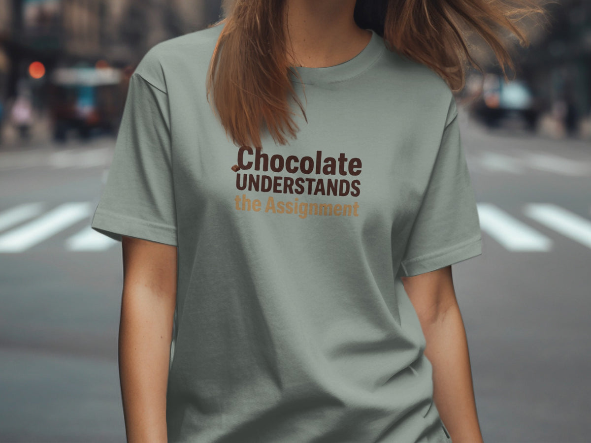 T-shirt with "Chocolate UNDERSTANDS the Assignment" text in brown and tan lettering.