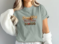 T-shirt graphic with text "Choose What Melts the Noise" and chocolate bar.