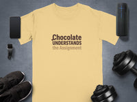 Yellow t-shirt with "Chocolate UNDERSTANDS the Assignment" text and gym accessories.