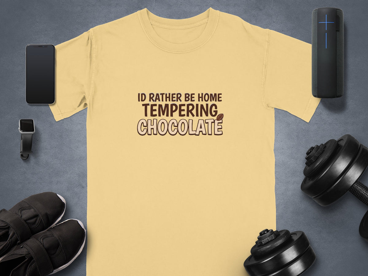 Light yellow t-shirt with "I'd Rather Be Home Tempering Chocolate" text and graphics.