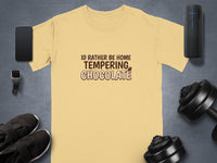 Light yellow t-shirt with "I'd Rather Be Home Tempering Chocolate" text and graphics.