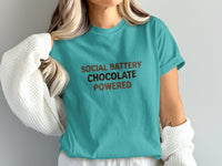 Teal t-shirt with brown text reading "SOCIAL BATTERY CHOCOLATE POWERED".