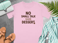 Pink t-shirt with "NO SMALL TALK Until DESSERT" text and chocolate piece.