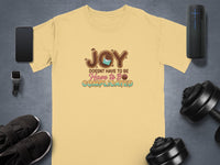Yellow t-shirt with "JOY DOESN'T HAVE TO BE COMPLICATED" text and chocolate graphic.