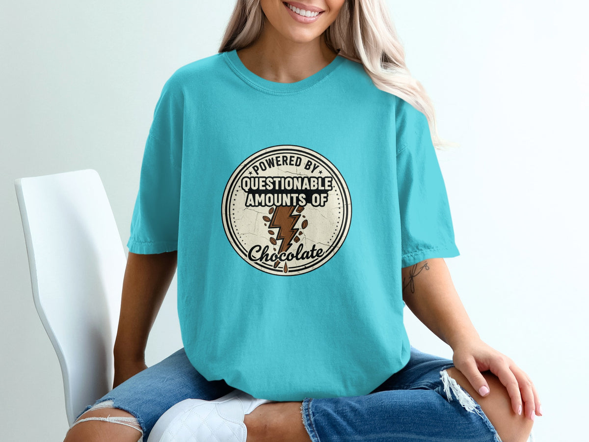Teal t-shirt with circular graphic reading "Powered By Questionable Amounts of Chocolate."