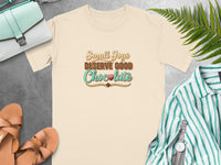 Cream t-shirt with "Small Joys Deserve Good Chocolate" text and chocolate graphic.