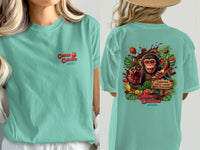 Teal t-shirt with "Cocoa Cabana" logo and monkey with chocolate and fruit graphic.