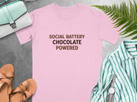 Pink t-shirt with text "SOCIAL BATTERY CHOCOLATE POWERED".