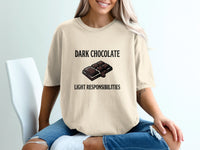 Light colored t-shirt with "DARK CHOCOLATE LIGHT RESPONSIBILITIES" text and chocolate bar graphic.