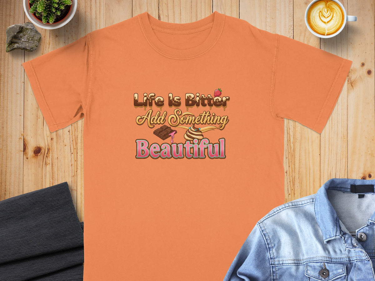 Orange t-shirt with "Life is Bitter Add Something Beautiful" text and dessert graphic.
