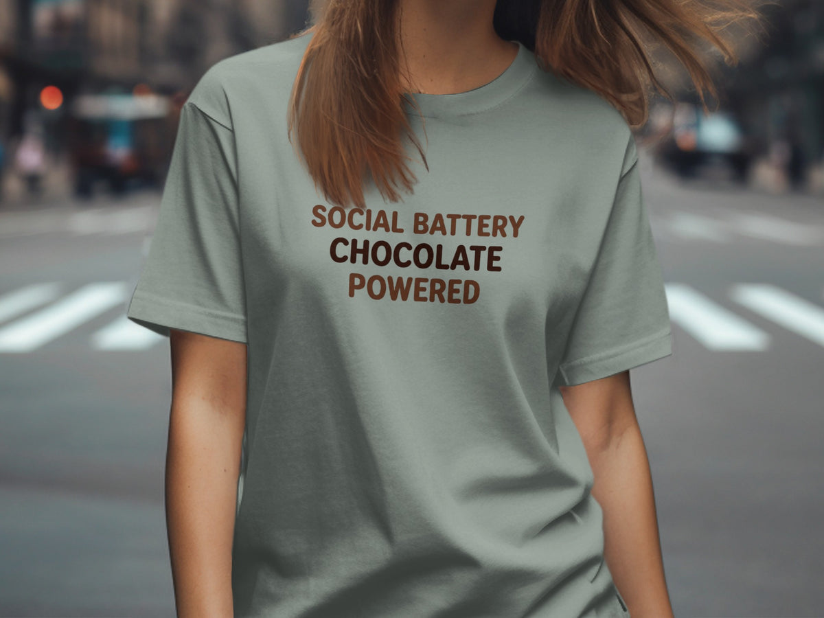 Light gray t-shirt with "SOCIAL BATTERY CHOCOLATE POWERED" printed in brown text.