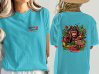 Turquoise t-shirt with a monkey-themed print including chocolate, fruit, and the text "Cocoa Cabana".
