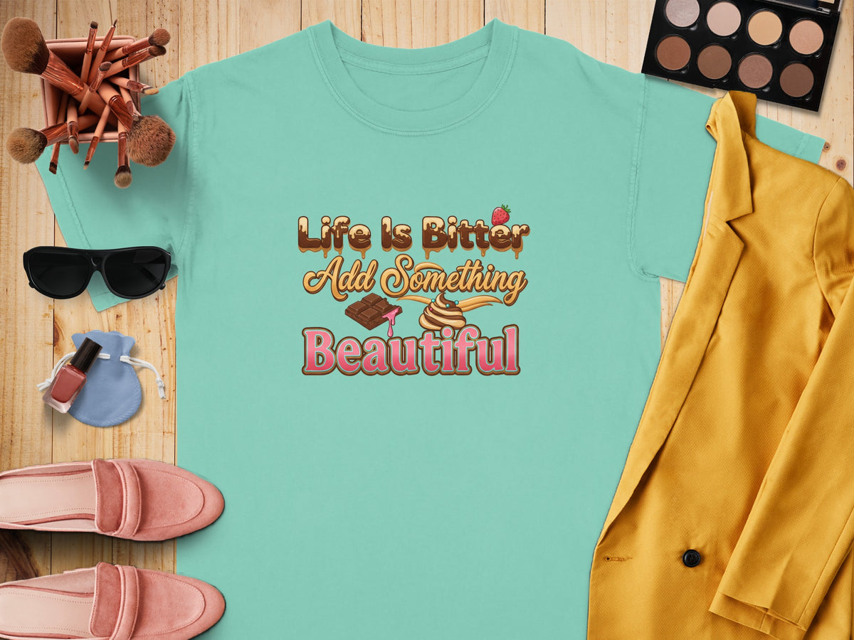 Aqua t-shirt with "Life Is Bitter Add Something Beautiful" text and chocolate illustrations.