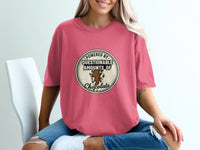 Pink t-shirt with a circular graphic reading "Powered by questionable amounts of chocolate."