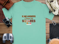 Turquoise t-shirt with text "SOME ANSWERS Come in SQUARES" and chocolate squares.