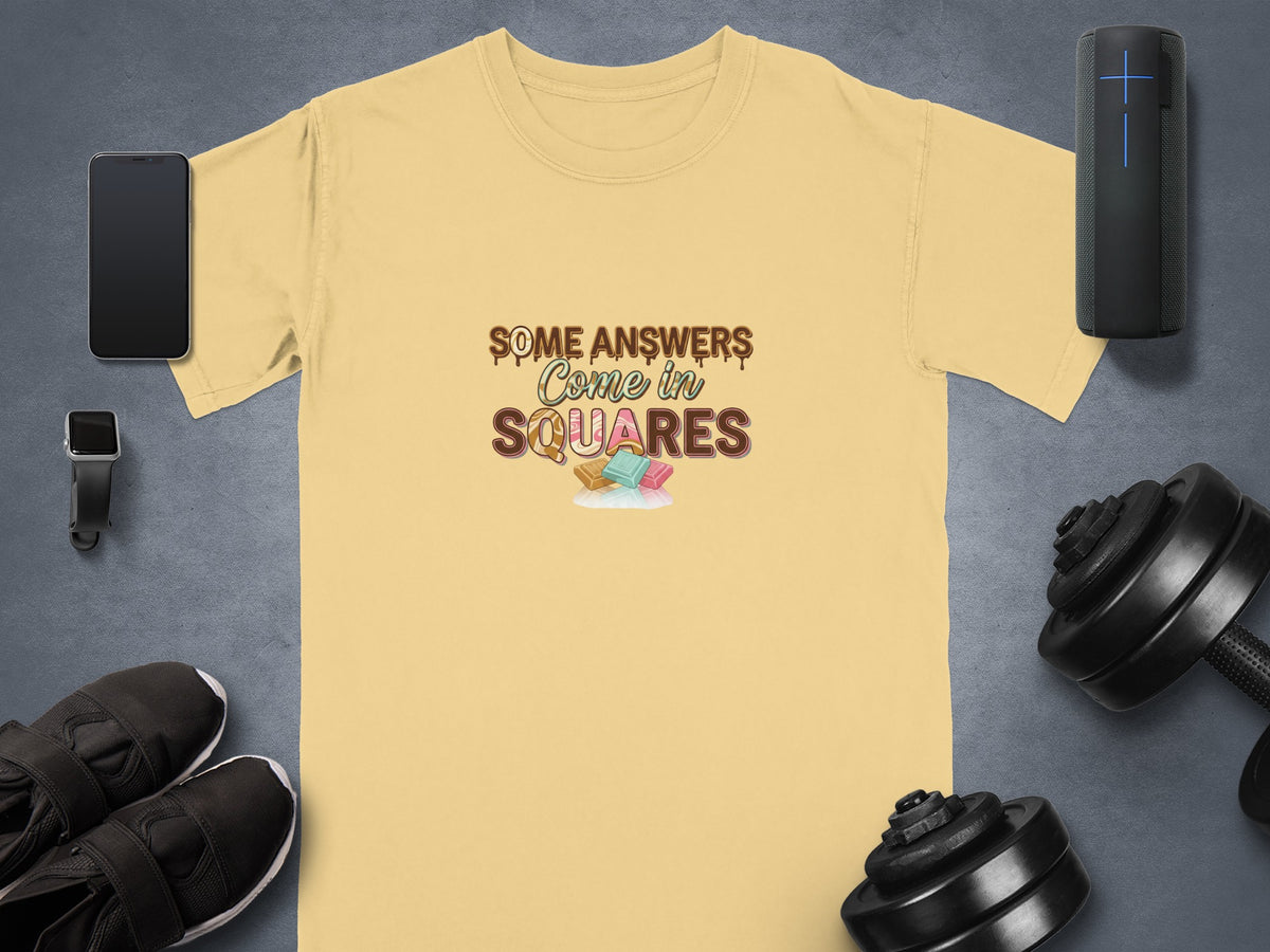 Yellow t-shirt with text "Some Answers Come in Squares" and chocolate squares graphic.