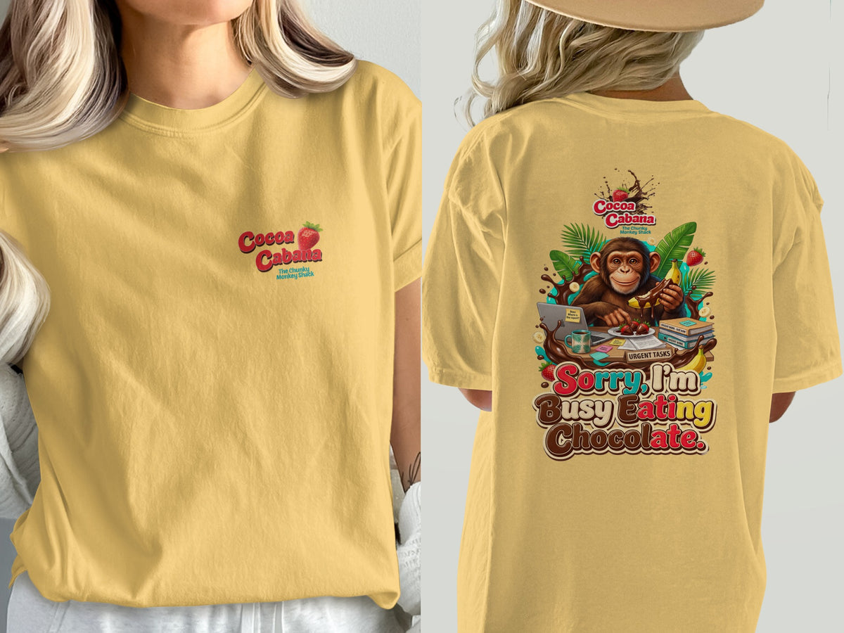 Yellow t-shirt with "Cocoa Cabana" logo and monkey with "Sorry I'm Busy Eating Chocolate" text.