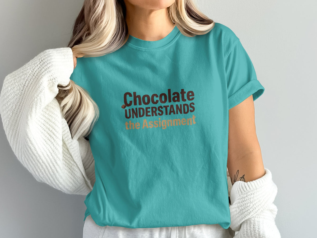 Turquoise t-shirt with "Chocolate UNDERSTANDS the Assignment" text.