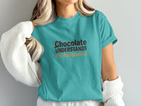 Turquoise t-shirt with "Chocolate UNDERSTANDS the Assignment" text.