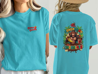 Turquoise t-shirt with "Cocoa Cabana" on the front and a monkey eating a banana on the back.