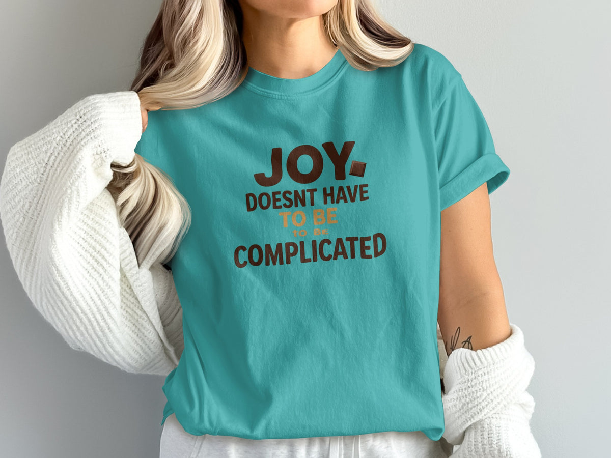 Teal t-shirt with brown text "JOY. DOESN'T HAVE TO BE COMPLICATED."
