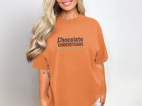 Orange t-shirt with "Chocolate Understands the Assignment" text.