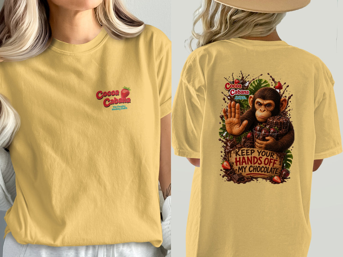 Yellow t-shirt with "Cocoa Cabana" logo and a monkey protecting chocolate.