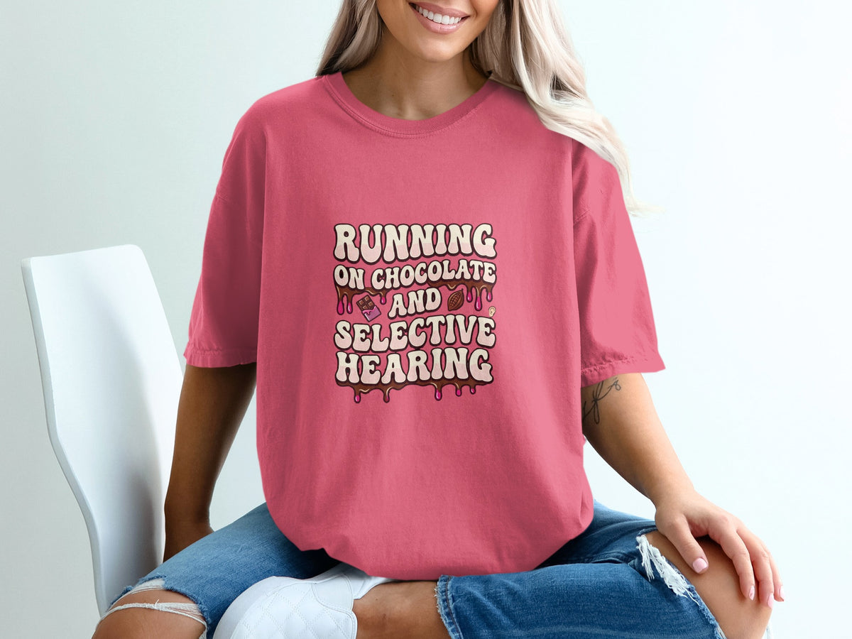 Pink t-shirt with graphic text "RUNNING ON CHOCOLATE AND SELECTIVE HEARING".
