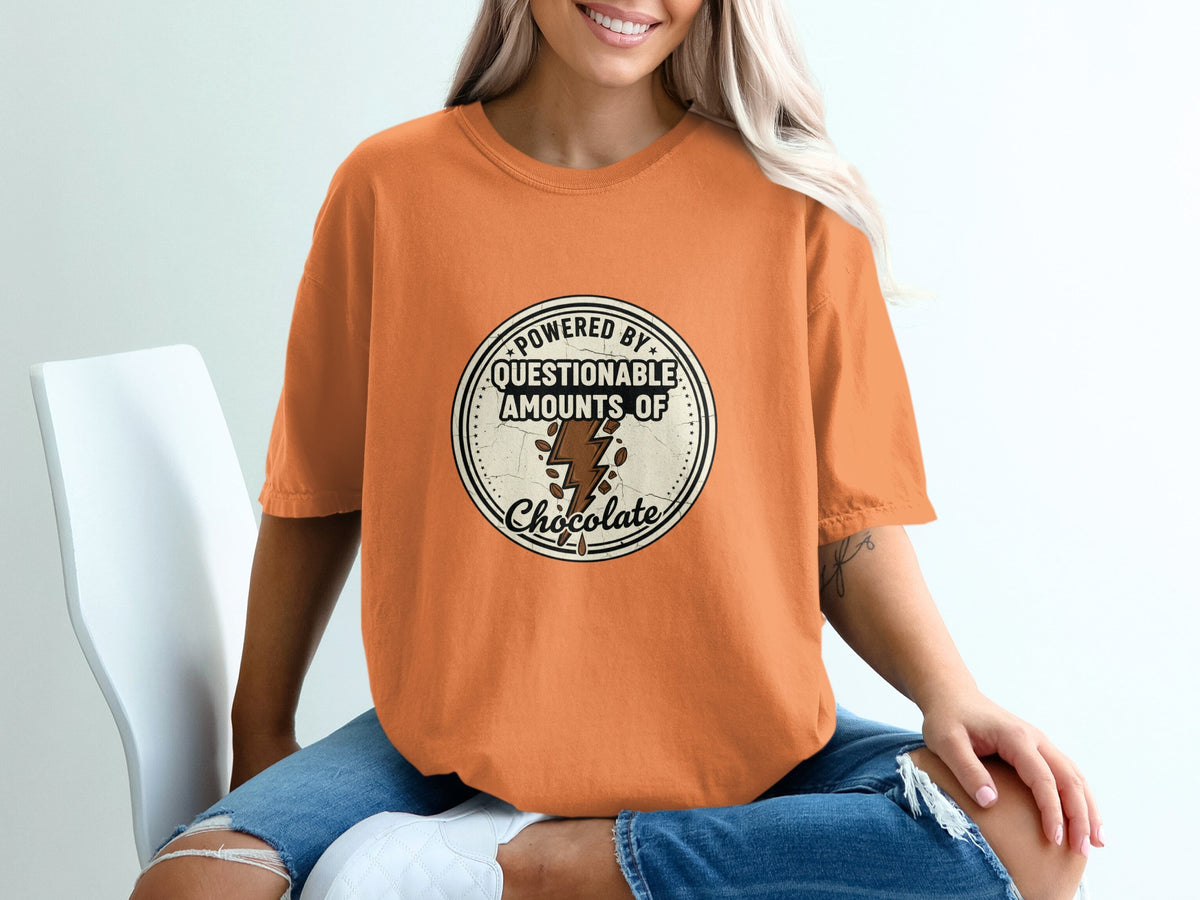 Orange t-shirt with "Powered by questionable amounts of chocolate" graphic.