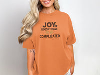 Orange t-shirt with "JOY DOESN'T HAVE TO BE COMPLICATED" text.
