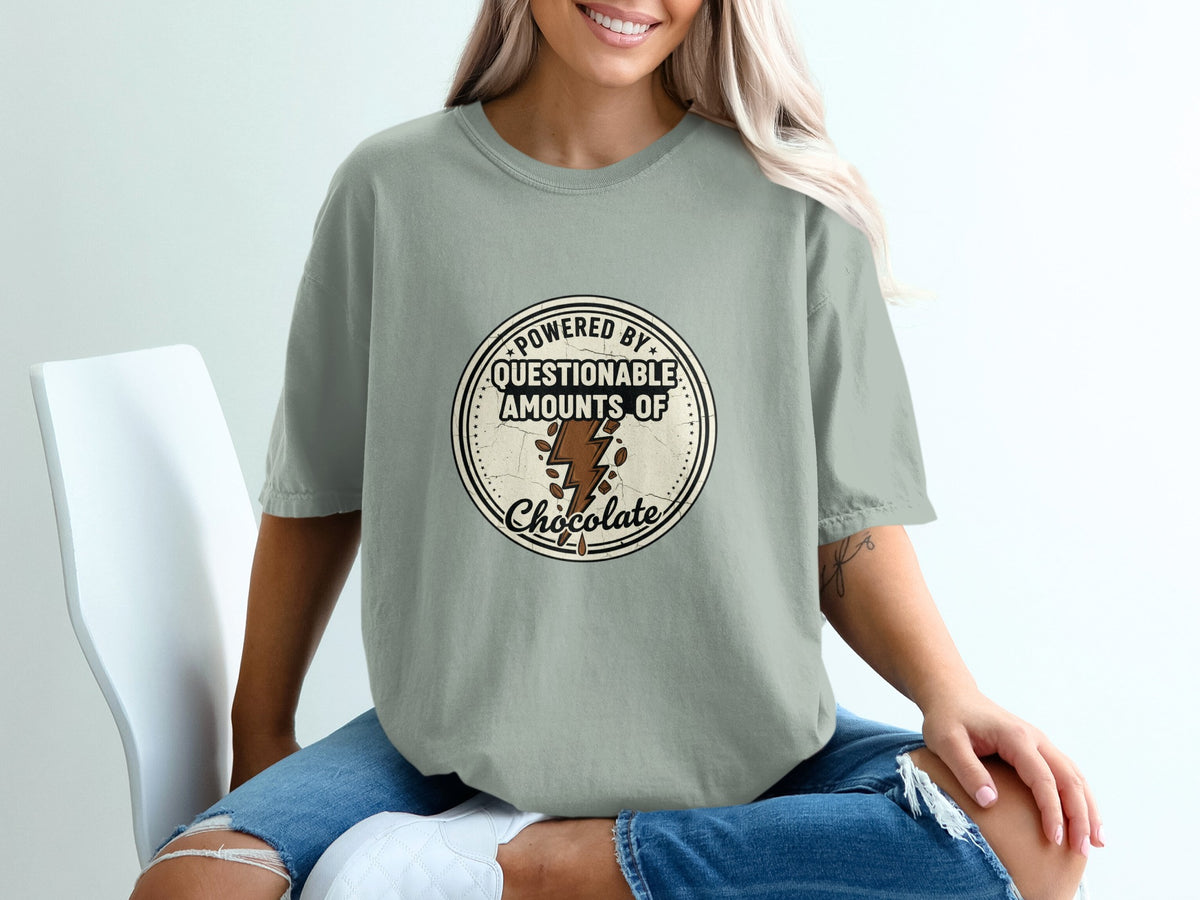 T-shirt graphic with text "Powered by questionable amounts of chocolate" and chocolate lightning bolt.
