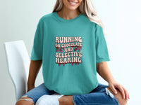 Teal t-shirt with text "RUNNING ON CHOCOLATE AND SELECTIVE HEARING" and chocolate graphics.