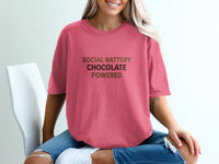 Pink t-shirt with text "SOCIAL BATTERY CHOCOLATE POWERED".