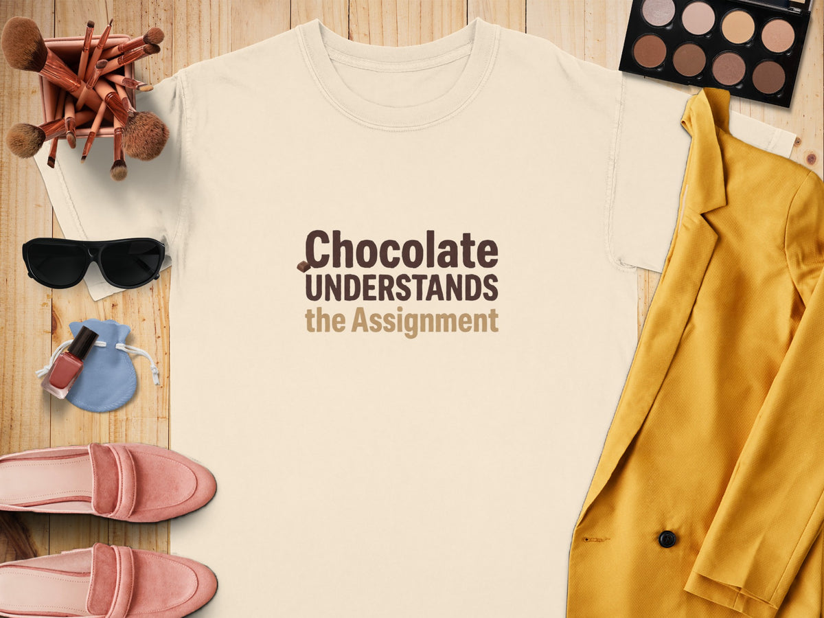 Cream t-shirt with "Chocolate Understands the Assignment" text.