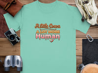 Mint green t-shirt with "A Little Cocoa A LOT MORE Human" text and heart graphic.
