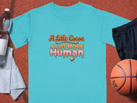 Turquoise t-shirt with "A Little Cocoa A LOT MORE Human" text.