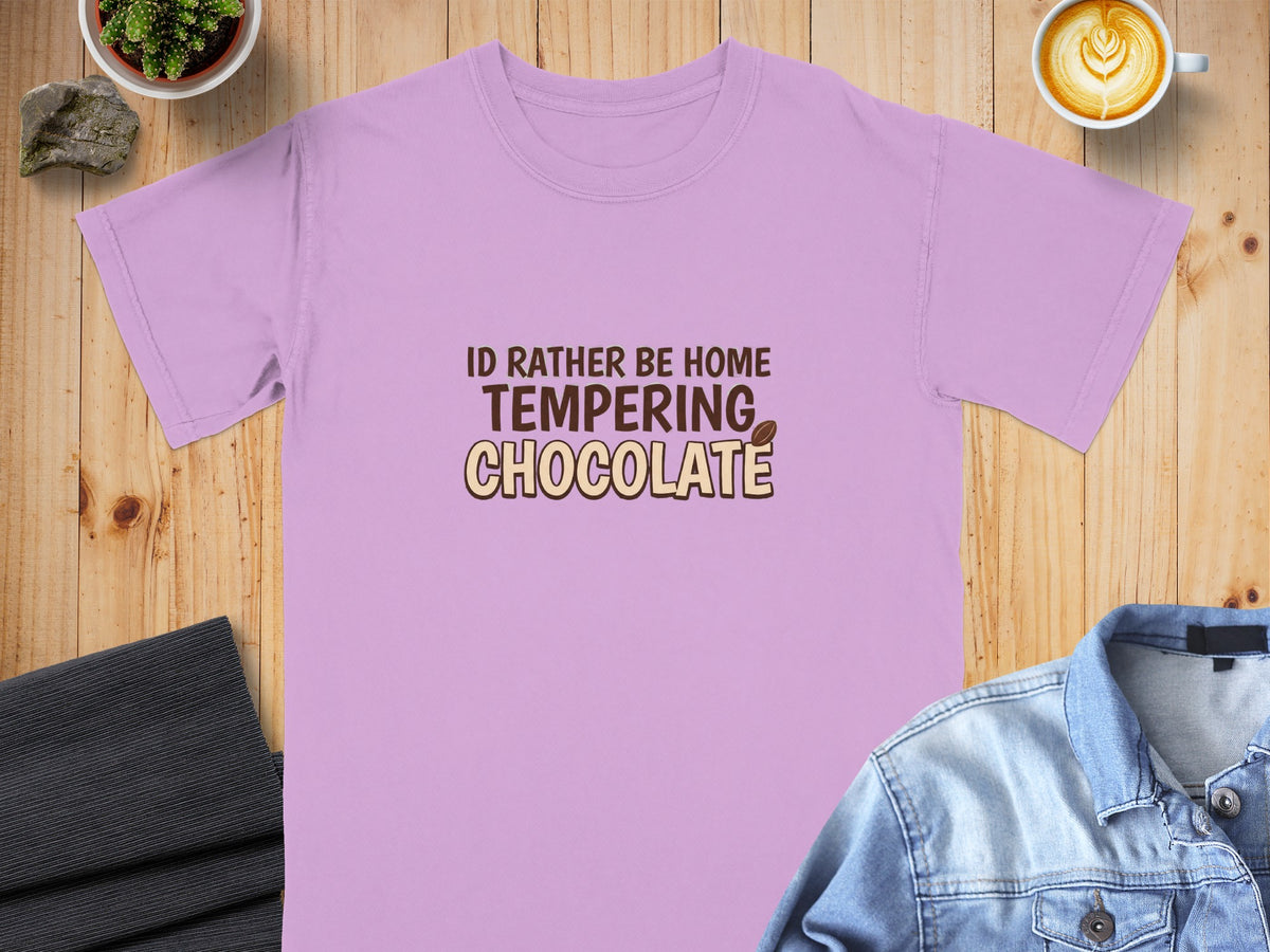 Purple t-shirt with text "I'd rather be home tempering chocolate".